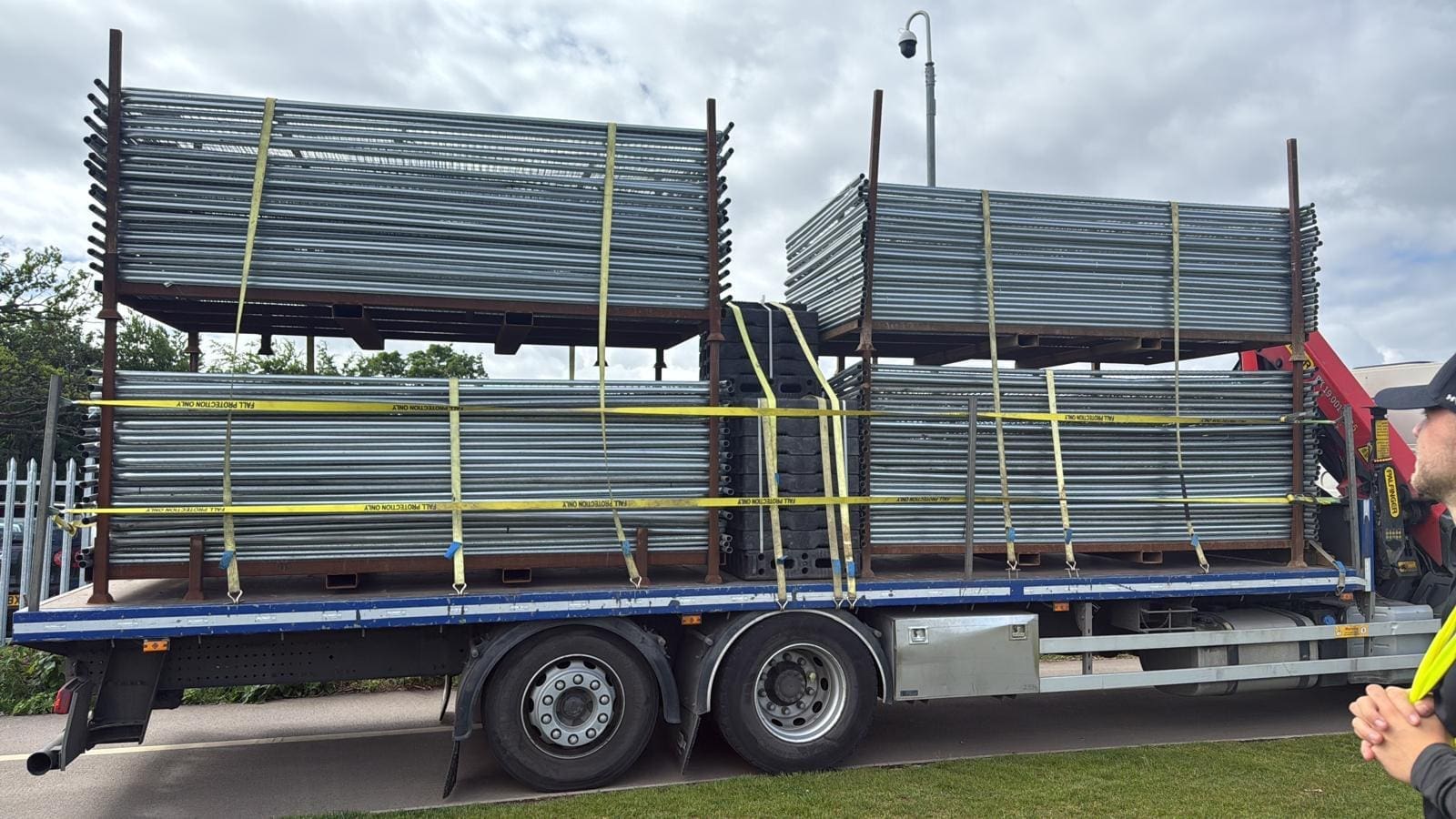 A lorry carrying stillages of HERAS fencing for the fence of a festival site